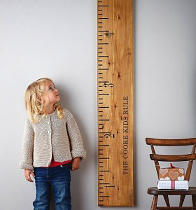 image of child next to meter stick measuring height