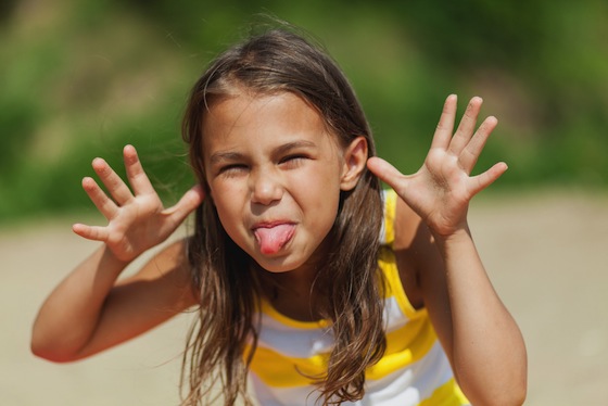 Image of a little kid making funny face integrated in a landing page