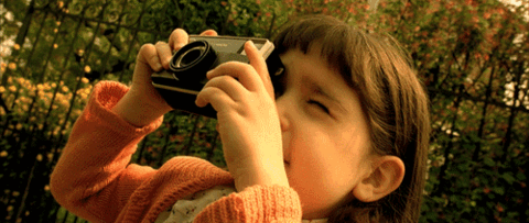 Little girl taking photos